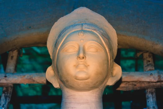 Handmade clay model of "Maa Durga" or " Devi Durga"- Hindu woman Idol close up. Snapped in the beginning of city famous Bengali festival of Kolkata or Calcutta, West Bengal, India, Asia