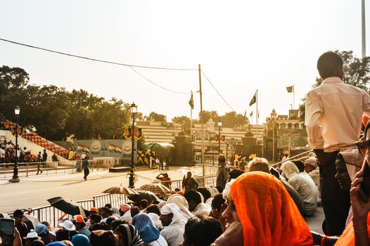 WAGHA BORDER, AMRITSAR, PUNJAB, INDIA - JUNE, 2017. People gathered in the lowering of flags ceremony. Its a daily military practice security forces of India and Pakistan jointly followed since 1959.