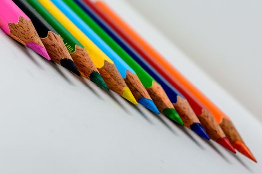 Selective sharp focus: Image of many colorful sketch pencils or a set of multi colored artist sketching or writing brush or tools instrument. Classroom or preschool decoration and design concept.