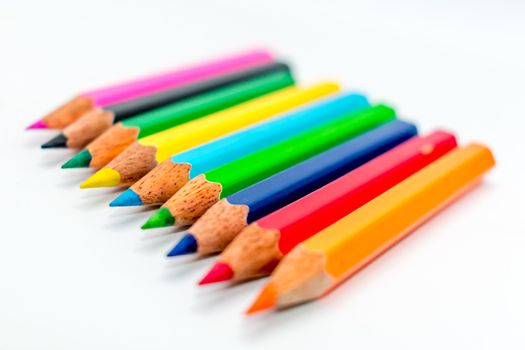 Selective sharp focus: Image of many colorful sketch pencils or a set of multi colored artist sketching or writing brush or tools instrument. Classroom or preschool decoration and design concept.