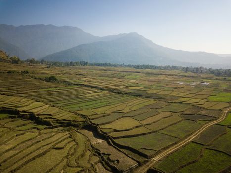 Aerial view of rural landscape in central Nepal. Paddy fields and hills in winter.