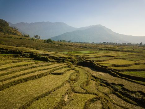 Aerial view of rural landscape in central Nepal. Paddy fields and hills in winter.