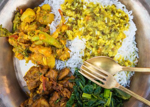 Traditional Nepali dal bhat served in metal plate