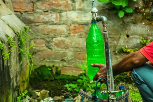 A man in using polycarbonate plastic containers for drinking water which can lead to serious health risks. Drinking water or any drink from plastic bottles could be harming for health and environment