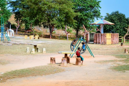 RANCHI, JHARKHAND, INDIA - MAY 14, 2017: Unidentified local little boys are playing in a village park. Jharhkand ethnic group of tribal village Children suffer of poverty due to bad economy.