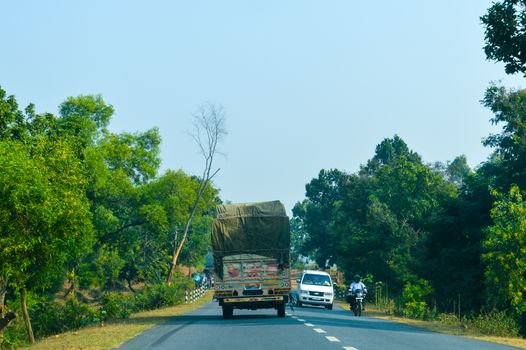Semi Truck with Cargo Trailer Drives with container on highway, transportation concept. Truck is First in the Column of Heavy Vehicles. G T Road, Kolkata India.