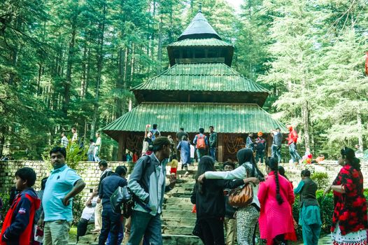 MANALI, INDIA - DECEMBER 9 Tourist come See the sacred Hidimda Devi Temple in Shimla, Kullu, Himachal Pradesh, noerthern India, Asia. Famous view of wooden covered architecture of Himalayan region.