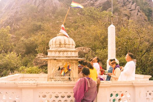MUKTAGIRI, MADHYA PRADESH, INDIA MAY 5 2016: A jain pilgrim devotee meditating in front of famous historical Jainism Temple. Muktagiri is a Jain Pilgrimage center and UNESCO World Herutage site.