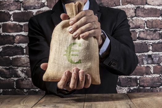 Man holding a big sack of money