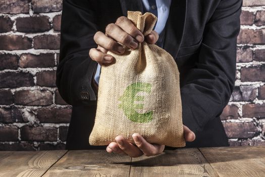 Man holding a big sack of money