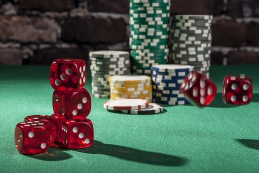 Dice and chips on green table with shadow