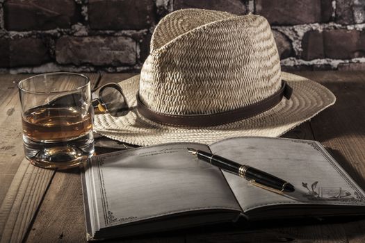 Hat and notebook on brown wood table