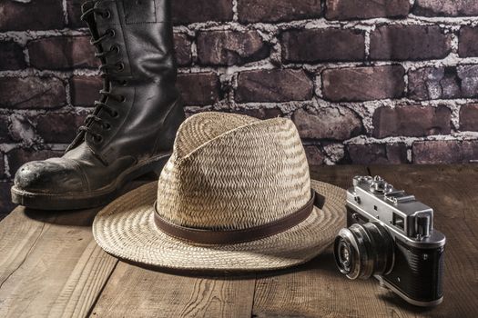 Hat and boot on brown wood table