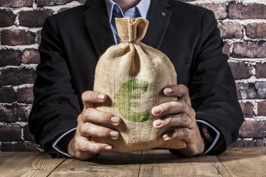 Man holding a big sack of money