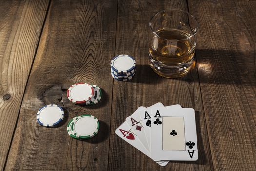 Alcohol, cards and chips on wood table