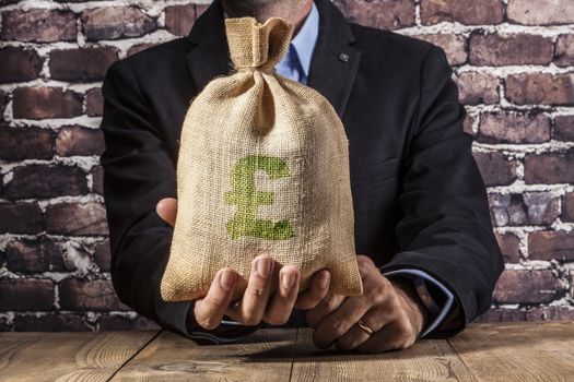 Man holding a big sack of money