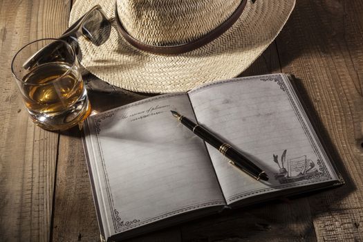 Hat and notebook on brown wood table