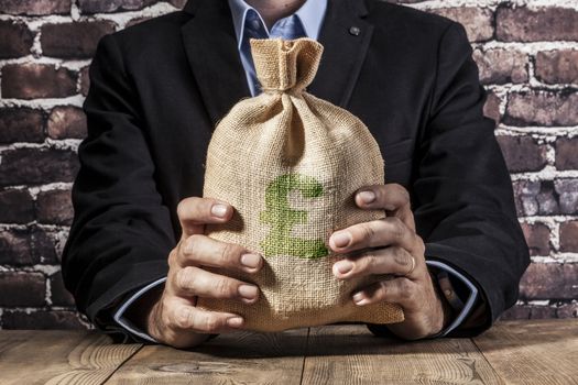 Man holding a big sack of money