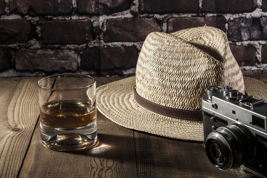 Hat and alcohon on brown wood table