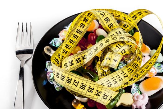 Meter and sweets isolated on white background