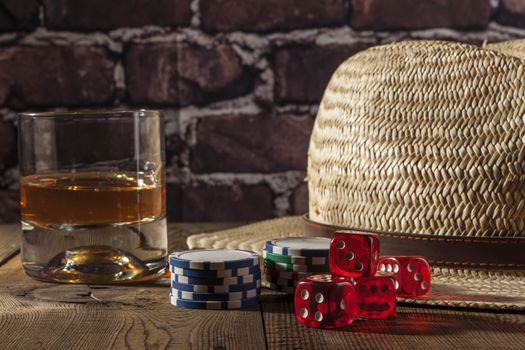 Hat and dice on brown wood table