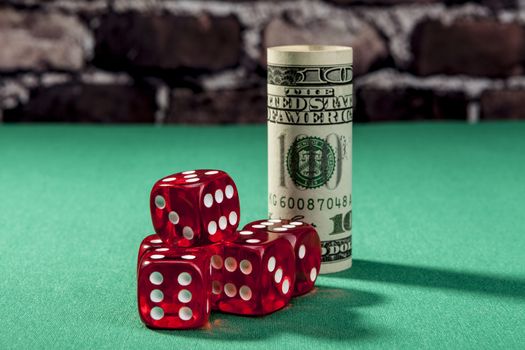 Dice and money on green table with shadow