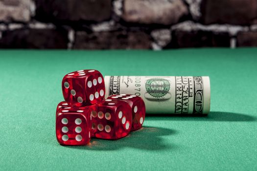 Dice and money on green table with shadow