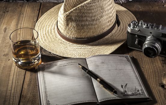 Hat and notebook on brown wood table