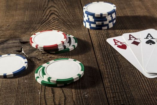Poker card and casino chips on wood table