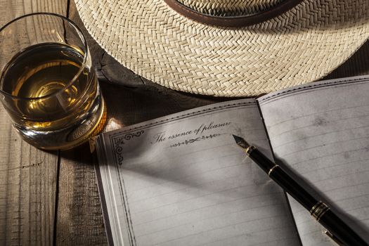 Hat and Alcohol on brown wood table