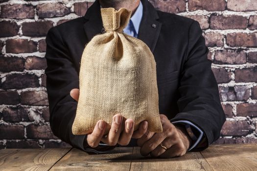 Man holding a big sack of money