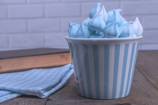 Blue sweets and book on wood table