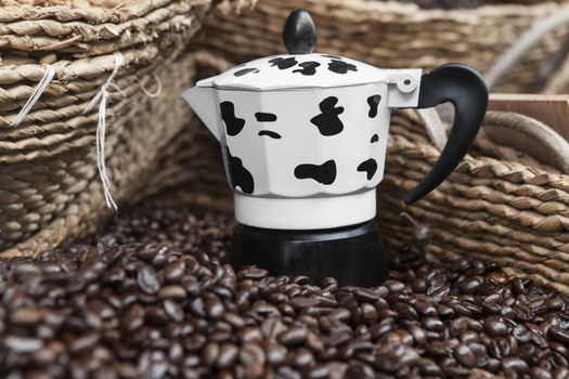 Black coffee beans and a black and white kettle