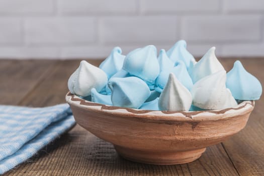 Blue sweets on wood table and white brick background