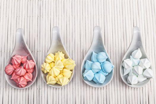 Yummy sweet stuff in colours on white wood