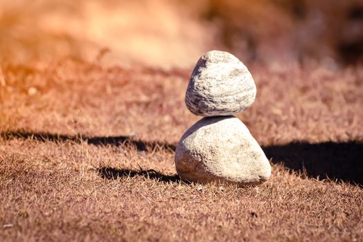 Heap of white stone stack of rock decoration in vertical style composition, copy space. Harmony, stability, strength, well being, concept. Useful in health, spa-therapy, alternative, medicine industry