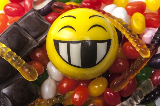 Happy emoticon and a lot of sweets