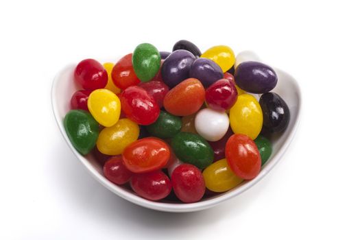 Bowl with candies isolated on white background with shadow