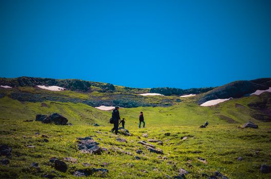 hikers with backpacks and trekking poles walking in Turkish highland