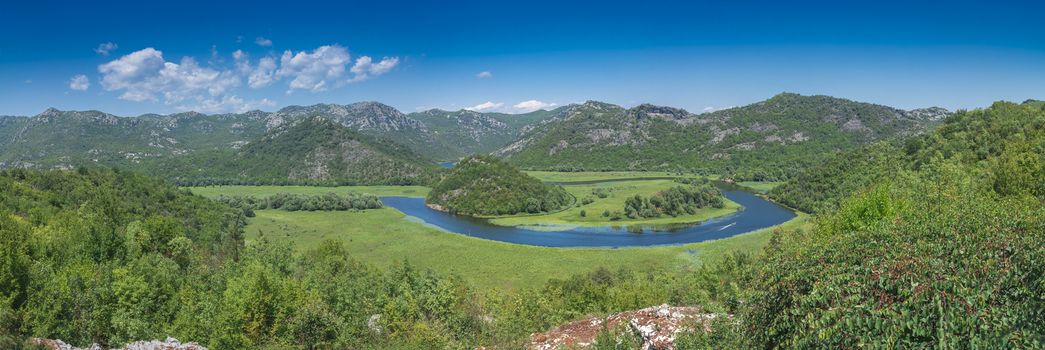 Panoramic view from above of Skadar lake and Crnojevica river in a national park, Montenegro, in a sunny summer day