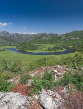 Panoramic view from above of Skadar lake and Crnojevica river in a national park, Montenegro, in a sunny summer day