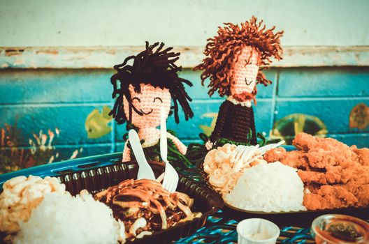 Just married wool puppets having lunch in their honeymoon in Hawaii, US