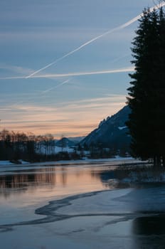 Sunrise on icy mountains lake in Tyrol, Austria.