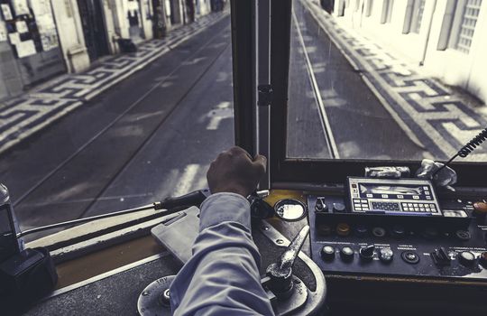 Driver tram in Lisbon, detail of a person wearing an old tram travelers in Portugal
