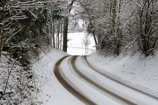 Road with trees and snow in Bavaria, Germany in winter