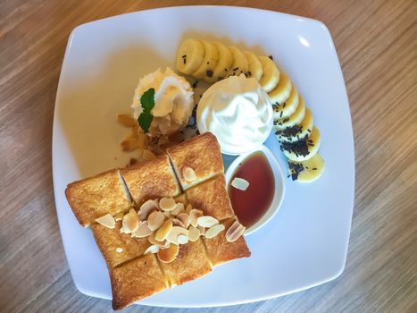 Ice cream dessert on the wooden table in a coffee cafe.