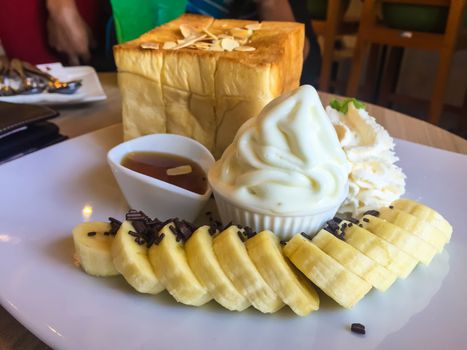 Ice cream dessert on the wooden table in a coffee cafe.