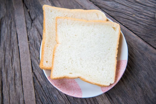 Slice of bread on a wooden table.