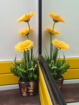 Yellow flowers that decorate the front of the mirror.