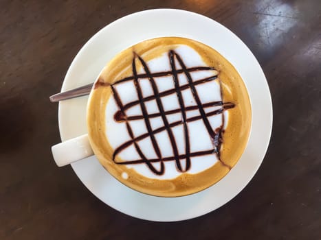 Hot coffee in white cup on the  table.